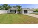 Charming single Gathering home boasts a manicured front lawn and a freshly painted exterior with attached garage at 7141 37Th N Ave, St Petersburg, FL 33710