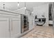 Modern kitchen island with a wine cooler, decorative cabinets and trim, and open to the dining area at 7141 37Th N Ave, St Petersburg, FL 33710