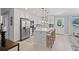 Updated kitchen featuring white cabinetry, quartz countertops, stainless steel appliances, and center island at 7141 37Th N Ave, St Petersburg, FL 33710