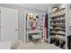 Custom walk-in closet with vanity area, built-in shelves, shoe racks, and elegant design at 7141 37Th N Ave, St Petersburg, FL 33710