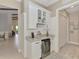 Charming bar area with granite countertops, wine rack and mini refrigerator at 749 Tailwind Pl, Sarasota, FL 34240