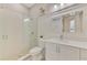 Modern bathroom features a glass enclosed shower, white vanity with quartz counters, and a large square mirror at 749 Tailwind Pl, Sarasota, FL 34240