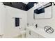 Modern bathroom with black and white decor, features sleek fixtures, vanity, and a shower with a curtain at 749 Tailwind Pl, Sarasota, FL 34240