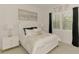Stylish bedroom with a white bed frame, matching nightstands, and black drapes, enhanced by gold decor at 749 Tailwind Pl, Sarasota, FL 34240