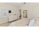 Bedroom with a white dresser, shuttered window, and a comfortable bed with neutral patterned bedding at 749 Tailwind Pl, Sarasota, FL 34240