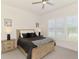 Bright bedroom with a natural wood bed frame, shuttered windows, and stylish bedside tables with lamps at 749 Tailwind Pl, Sarasota, FL 34240
