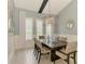 Stylish dining room features a wood table, modern lighting and windows with white shutters at 749 Tailwind Pl, Sarasota, FL 34240