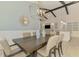Elegant dining room with modern lighting fixture, wood table, and an open floorplan at 749 Tailwind Pl, Sarasota, FL 34240
