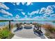 Scenic outdoor fire pit area overlooking the tranquil lake, perfect for relaxing evenings at 749 Tailwind Pl, Sarasota, FL 34240