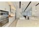 Kitchen features stainless steel appliances, white cabinets and stone countertops at 749 Tailwind Pl, Sarasota, FL 34240