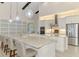 Kitchen with stainless steel appliances, large island, and elegant pendant lighting at 749 Tailwind Pl, Sarasota, FL 34240