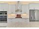 Modern kitchen featuring stainless steel appliances, white cabinets and backsplash at 749 Tailwind Pl, Sarasota, FL 34240