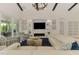 Spacious living room with a modern fireplace, built-in shelving, and a comfortable seating area at 749 Tailwind Pl, Sarasota, FL 34240