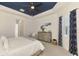 Bright main bedroom with tray ceilings, a ceiling fan, neutral decor and comfortable bed at 749 Tailwind Pl, Sarasota, FL 34240