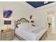 Cozy main bedroom with blue tray ceilings, a comfortable bed, and neutral decor at 749 Tailwind Pl, Sarasota, FL 34240
