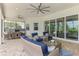 Spacious covered patio with comfortable seating, ceiling fans, and an outdoor kitchen area for entertaining at 749 Tailwind Pl, Sarasota, FL 34240