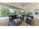 Enjoy the outdoors with a screened-in lanai including ample seating and a summer kitchen, perfect for entertaining at 749 Tailwind Pl, Sarasota, FL 34240