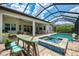 A covered patio area featuring a bar and a great view of the pool and lanai at 749 Tailwind Pl, Sarasota, FL 34240