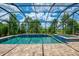 Enjoy the outdoors with a screened-in pool and spa featuring elegant tiling and a beautiful view at 749 Tailwind Pl, Sarasota, FL 34240
