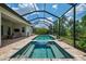 Beautiful in-ground pool and spa with brick pavers and screened enclosure at 749 Tailwind Pl, Sarasota, FL 34240