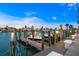 Evening view of a boat dock showcasing tranquil waterfront living with boats and clear skies at 773 Spanish N Dr, Longboat Key, FL 34228