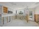 Kitchen featuring white cabinets, tile backsplash, and a view to the outdoors at 773 Spanish N Dr, Longboat Key, FL 34228