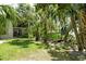 A lush backyard with green grass and plenty of trees provides a serene outdoor space at 7876 Eagle Creek Dr, Sarasota, FL 34243