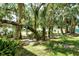 Lush backyard with mature trees offering plenty of shade and privacy at 7876 Eagle Creek Dr, Sarasota, FL 34243