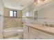Renovated bathroom with a combination tub and shower, and updated vanity showcasing modern design at 7876 Eagle Creek Dr, Sarasota, FL 34243