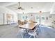 A bright clubhouse interior with seating, an exit to the pool, and a kitchen at 7876 Eagle Creek Dr, Sarasota, FL 34243