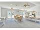 Bright clubhouse interior features seating areas, a kitchen, and access to pool via french doors at 7876 Eagle Creek Dr, Sarasota, FL 34243