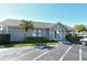A well-maintained clubhouse with a manicured lawn enhances curb appeal at 7876 Eagle Creek Dr, Sarasota, FL 34243