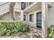 The entrance of the condo has a doormat that reads 'Home Sweet Home', along with tropical plants at 7876 Eagle Creek Dr, Sarasota, FL 34243