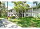 Inviting two-story condo building featuring lush landscaping and a well-maintained lawn at 7876 Eagle Creek Dr, Sarasota, FL 34243