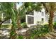 Exterior of the property showcasing lush landscaping and mature trees at 7876 Eagle Creek Dr, Sarasota, FL 34243