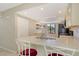 Kitchen boasts sleek bar seating, bright stone countertops, and updated appliances for a modern living experience at 7876 Eagle Creek Dr, Sarasota, FL 34243