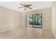 Bright and open living room with tile floors, ceiling fan, and access to a private outdoor patio at 7876 Eagle Creek Dr, Sarasota, FL 34243