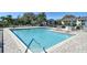 A spacious community pool with ample seating and clear blue water for recreation and relaxation at 7876 Eagle Creek Dr, Sarasota, FL 34243