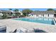 A large community pool with seating and umbrellas provides a refreshing amenity for residents at 7876 Eagle Creek Dr, Sarasota, FL 34243