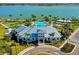Aerial view of the community center and pool area, with lush landscaping and lake views at 7889 Mainsail Ln, Sarasota, FL 34240