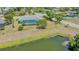 A high angle view of a screened pool and pond at 7912 Estates Dr, Sarasota, FL 34243