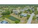 Aerial view of the home with a pool overlooking a tranquil pond in a lush, green community at 7912 Estates Dr, Sarasota, FL 34243