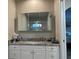 Bathroom featuring a white vanity with granite countertop and a mirrored medicine cabinet at 7912 Estates Dr, Sarasota, FL 34243
