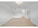 Bright bedroom with light wood floors, white walls, and an open doorway, creating a spacious feel at 7912 Estates Dr, Sarasota, FL 34243