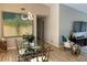 Elegant dining room with modern lighting and a large painting as a focal point at 7912 Estates Dr, Sarasota, FL 34243