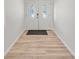 The foyer presents a clean aesthetic with wood-style floors and a decorative glass door at 7912 Estates Dr, Sarasota, FL 34243