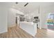 Modern kitchen features an island, stainless steel appliances, and seamless access to the outdoor pool area at 7912 Estates Dr, Sarasota, FL 34243