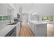 Open kitchen with stainless steel appliances, island, and views of the living area, perfect for entertaining at 7912 Estates Dr, Sarasota, FL 34243