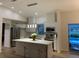 Bright kitchen featuring stainless steel appliances, a center island, and modern pendant lighting at 7912 Estates Dr, Sarasota, FL 34243