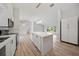 Bright, modern kitchen featuring a large island, stainless steel appliances, and an open layout at 7912 Estates Dr, Sarasota, FL 34243